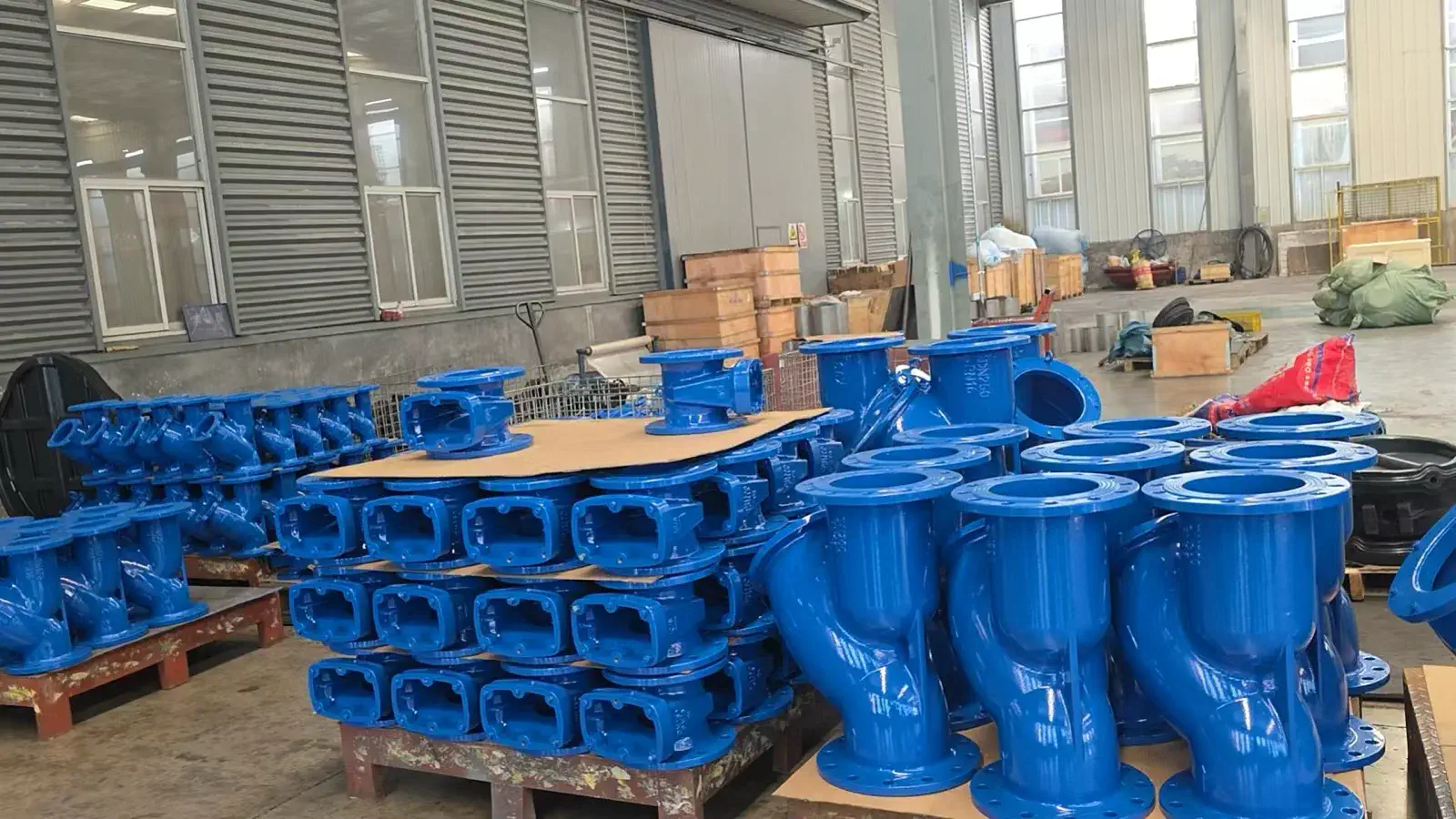 Finished waterworks valves staged in the yard, ready for receiving inspection.